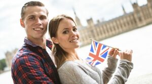 couple holding UK flag in front of Big Ben